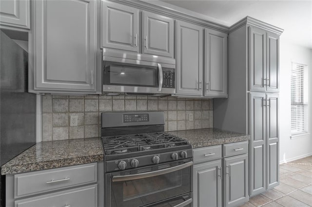 201 NW 160th Ter, Edmond, OK 73013 - kitchen with appliances with stainless steel finishes, gray cabinets, and tasteful backsplash