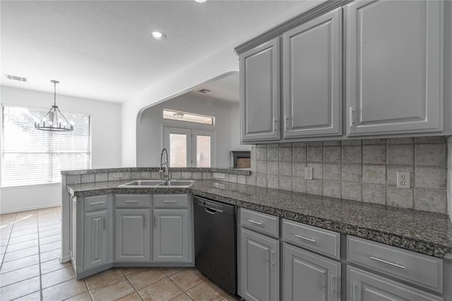 201 NW 160th Ter, Edmond, OK 73013 - kitchen featuring gray cabinetry, dishwasher, a peninsula, light tile patterned floors, and decorative backsplash