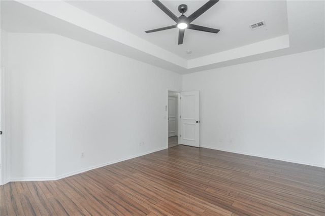 201 NW 160th Ter, Edmond, OK 73013 - spare room featuring ceiling fan, a tray ceiling, and wood finished floors