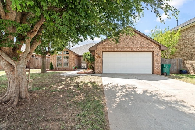 4705 Stag Horn Dr, Yukon, OK 73099 - view of front of house with brick siding, concrete driveway, and an attached garage