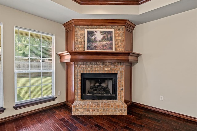 4705 Stag Horn Dr, Yukon, OK 73099 - detailed view of a tray ceiling, wood finished floors, a brick fireplace, and crown molding