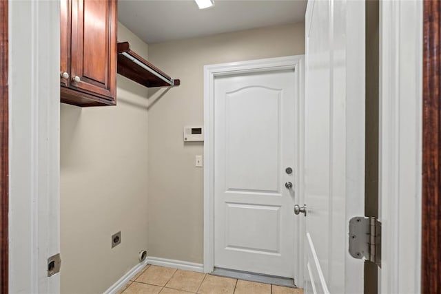4705 Stag Horn Dr, Yukon, OK 73099 - laundry area with cabinet space, electric dryer hookup, and light tile patterned floors