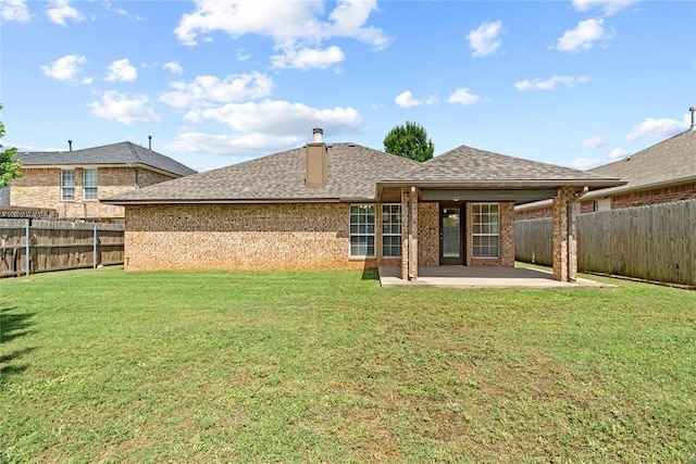 4705 Stag Horn Dr, Yukon, OK 73099 - back of house featuring a patio, brick siding, a fenced backyard, a shingled roof, and a chimney