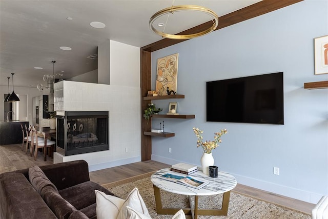 907 NW 9th St Unit B, Oklahoma City, OK 73106 - living room featuring wood finished floors, a fireplace, and recessed lighting