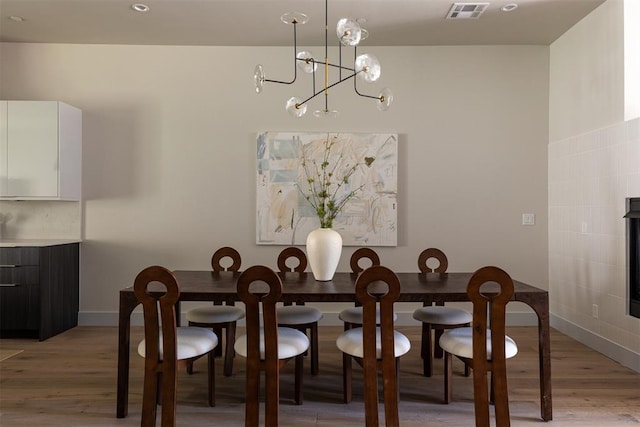 907 NW 9th St Unit B, Oklahoma City, OK 73106 - dining area featuring light wood-style flooring and a chandelier