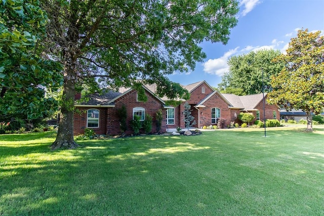 10517 SE 49th St, Oklahoma City, OK 73150 - view of front of home with a front lawn and brick siding