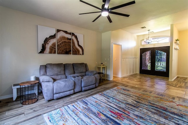 10517 SE 49th St, Oklahoma City, OK 73150 - living area with ceiling fan, wood finished floors, a wainscoted wall, french doors, and a chandelier