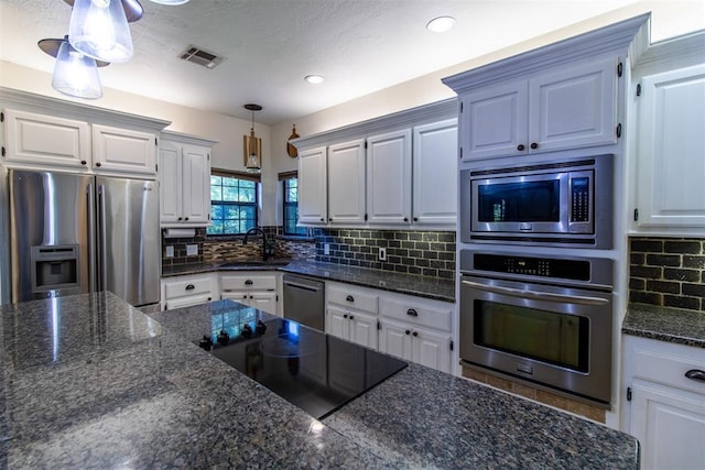 10517 SE 49th St, Oklahoma City, OK 73150 - kitchen featuring stainless steel appliances, tasteful backsplash, pendant lighting, white cabinets, and recessed lighting