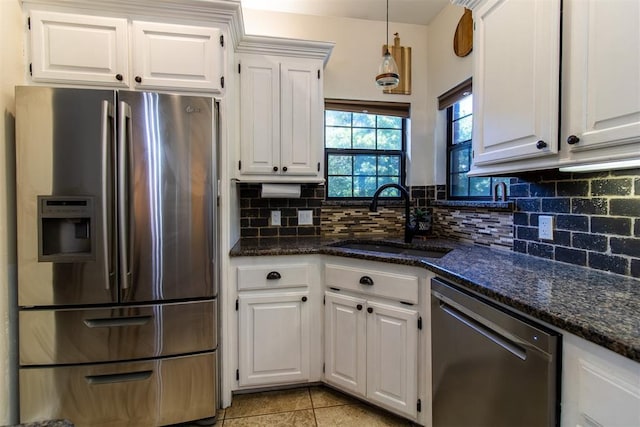 10517 SE 49th St, Oklahoma City, OK 73150 - kitchen featuring stainless steel appliances, white cabinets, backsplash, and light tile patterned floors