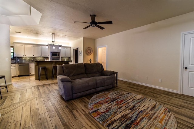 10517 SE 49th St, Oklahoma City, OK 73150 - living room with a ceiling fan and light wood-style floors