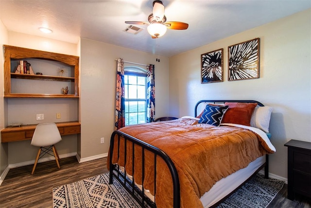 10517 SE 49th St, Oklahoma City, OK 73150 - bedroom with built in study area, wood finished floors, and a ceiling fan