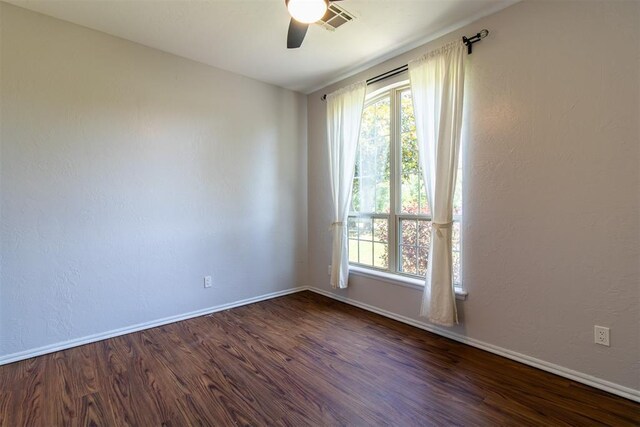 10517 SE 49th St, Oklahoma City, OK 73150 - spare room with a ceiling fan and dark wood finished floors