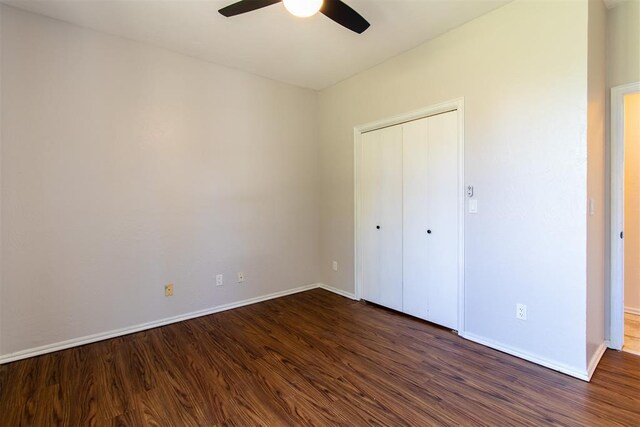 10517 SE 49th St, Oklahoma City, OK 73150 - unfurnished bedroom featuring dark wood finished floors, a closet, and a ceiling fan