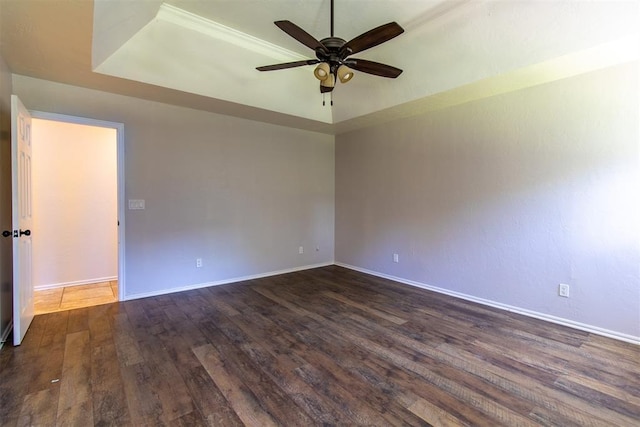 10517 SE 49th St, Oklahoma City, OK 73150 - empty room featuring a tray ceiling, ceiling fan, and dark wood-style floors