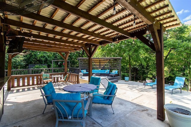10517 SE 49th St, Oklahoma City, OK 73150 - view of patio with an outdoor living space, outdoor dining area, and view of wooded area