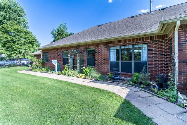 10517 SE 49th St, Oklahoma City, OK 73150 - rear view of property featuring roof with shingles, brick siding, and a lawn