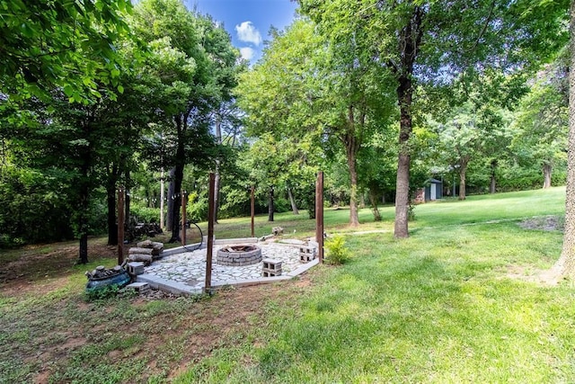 10517 SE 49th St, Oklahoma City, OK 73150 - view of green lawn with an outdoor fire pit, a storage shed, and view of scattered trees
