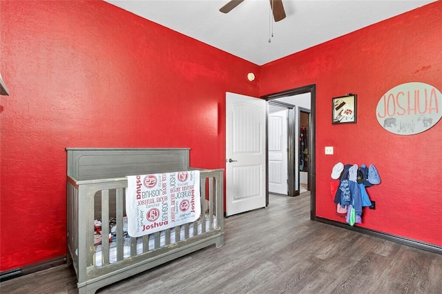 5901 NE Watts Rd, Elgin, OK 73538 - bedroom with a textured wall, wood finished floors, and a ceiling fan