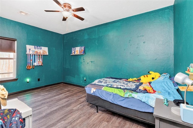 5901 NE Watts Rd, Elgin, OK 73538 - bedroom with wood finished floors and ceiling fan