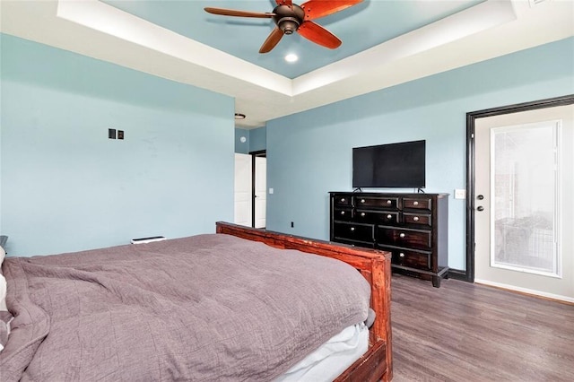 5901 NE Watts Rd, Elgin, OK 73538 - bedroom with a raised ceiling, wood finished floors, and ceiling fan