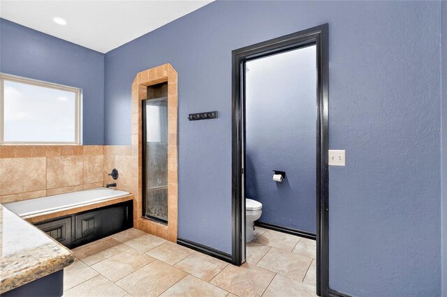 5901 NE Watts Rd, Elgin, OK 73538 - full bath with a garden tub, tile patterned flooring, a shower stall, and a textured wall