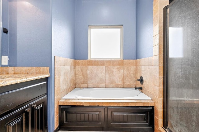 5901 NE Watts Rd, Elgin, OK 73538 - bathroom featuring a garden tub, vanity, and a shower stall