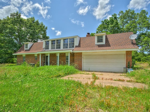 356818 E 1070th Rd, Prague, OK 74864 - traditional-style home with brick siding, a garage, driveway, a chimney, and a shingled roof