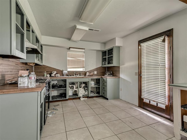 356818 E 1070th Rd, Prague, OK 74864 - kitchen with open shelves, decorative backsplash, and light tile patterned floors