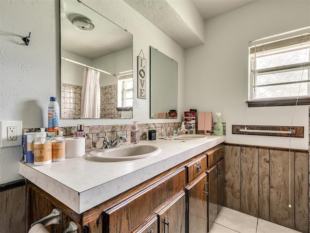 356818 E 1070th Rd, Prague, OK 74864 - bathroom with double vanity, wainscoting, and a shower with shower curtain