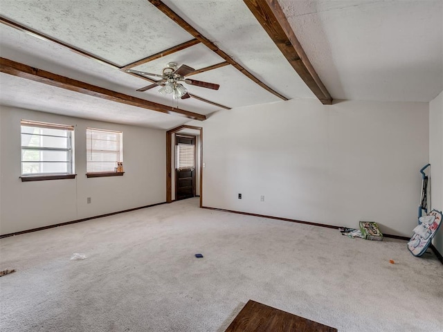 356818 E 1070th Rd, Prague, OK 74864 - empty room featuring beamed ceiling, ceiling fan, and carpet flooring