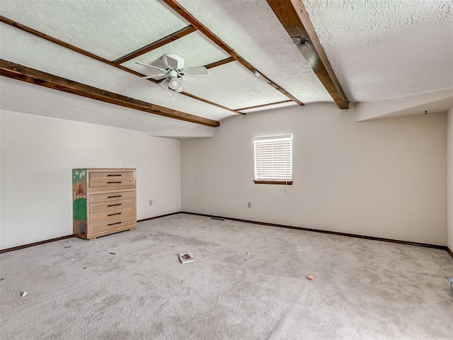356818 E 1070th Rd, Prague, OK 74864 - empty room with beam ceiling, a textured ceiling, carpet flooring, and a ceiling fan