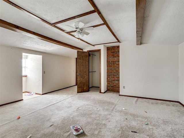 356818 E 1070th Rd, Prague, OK 74864 - unfurnished bedroom featuring a textured ceiling, carpet floors, beam ceiling, multiple closets, and ceiling fan