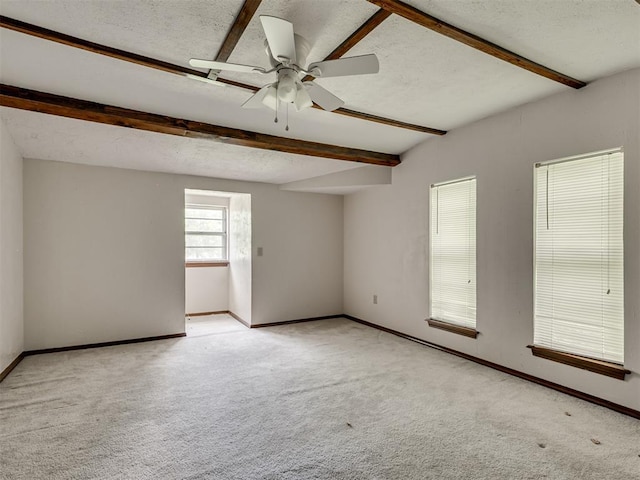 356818 E 1070th Rd, Prague, OK 74864 - carpeted spare room with beamed ceiling, a textured ceiling, and a ceiling fan