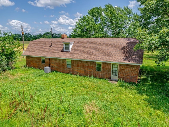 356818 E 1070th Rd, Prague, OK 74864 - back of house featuring a chimney and brick siding