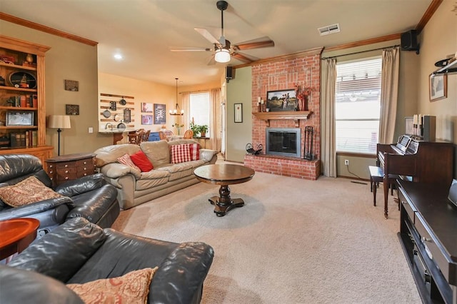 2704 Jills Trl, Edmond, OK 73012 - living area with a ceiling fan, crown molding, a brick fireplace, carpet floors, and a chandelier