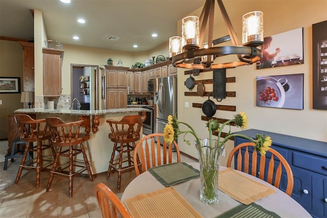 2704 Jills Trl, Edmond, OK 73012 - dining room with a chandelier, recessed lighting, and light tile patterned floors