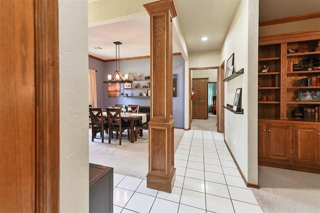 2704 Jills Trl, Edmond, OK 73012 - hall featuring light carpet, a chandelier, ornamental molding, decorative columns, and light tile patterned flooring