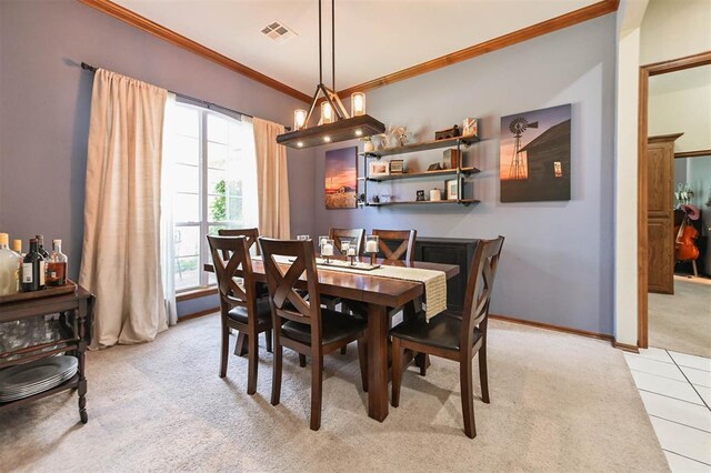 2704 Jills Trl, Edmond, OK 73012 - dining room with light colored carpet, ornamental molding, and light tile patterned flooring