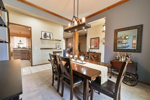 2704 Jills Trl, Edmond, OK 73012 - dining space featuring light colored carpet, light tile patterned floors, and crown molding