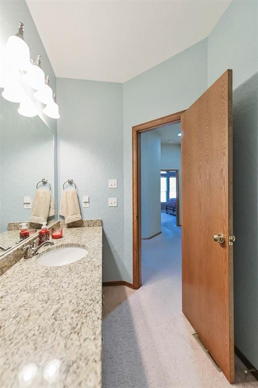 2704 Jills Trl, Edmond, OK 73012 - bathroom with vanity and a chandelier