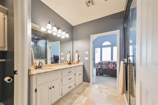 2704 Jills Trl, Edmond, OK 73012 - full bathroom featuring ensuite bathroom, double vanity, an enclosed shower, a textured wall, and stone tile floors