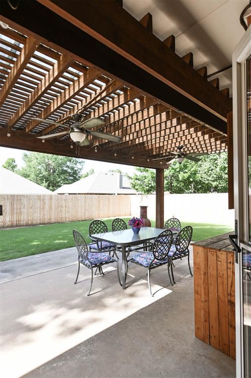 2704 Jills Trl, Edmond, OK 73012 - fenced backyard featuring outdoor dining area, a pergola, and a patio area