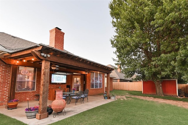 2704 Jills Trl, Edmond, OK 73012 - back of property with brick siding, a chimney, a patio, and a shingled roof