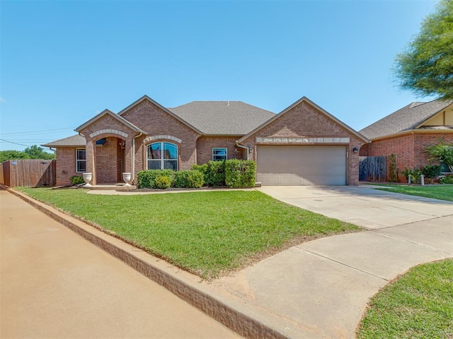 11749 SW 16th St, Yukon, OK 73099 - view of front of home featuring brick siding, a garage, concrete driveway, and a shingled roof