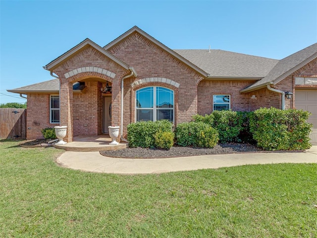 11749 SW 16th St, Yukon, OK 73099 - view of front of property featuring brick siding, a shingled roof, and a garage