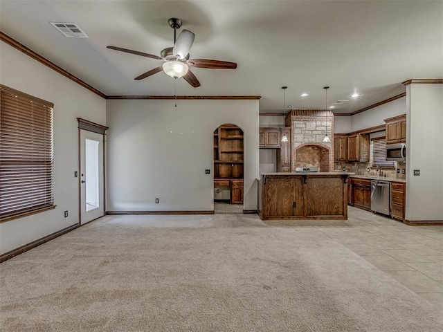 11749 SW 16th St, Yukon, OK 73099 - kitchen with stainless steel appliances, ornamental molding, a ceiling fan, backsplash, and decorative light fixtures