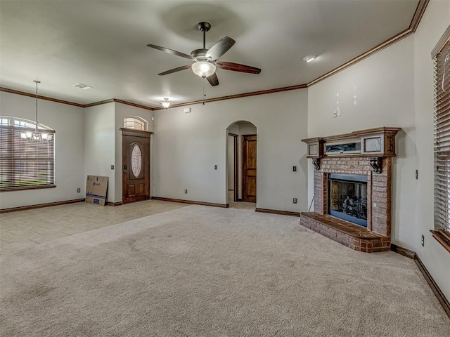 11749 SW 16th St, Yukon, OK 73099 - unfurnished living room with arched walkways, a ceiling fan, a brick fireplace, light carpet, and ornamental molding