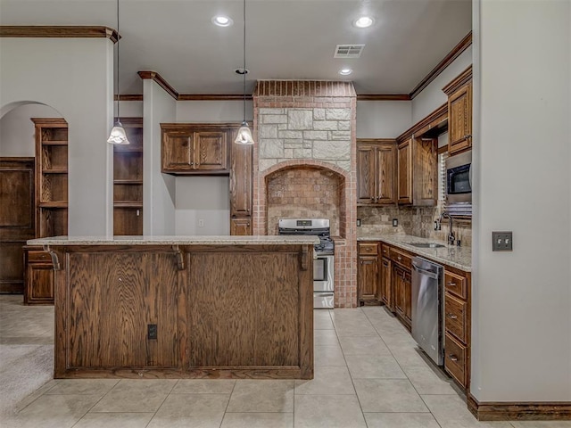 11749 SW 16th St, Yukon, OK 73099 - kitchen with stainless steel appliances, ornamental molding, a center island, decorative backsplash, and light stone counters