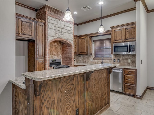 11749 SW 16th St, Yukon, OK 73099 - kitchen with appliances with stainless steel finishes, crown molding, backsplash, a kitchen breakfast bar, and decorative light fixtures