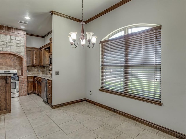 11749 SW 16th St, Yukon, OK 73099 - kitchen featuring appliances with stainless steel finishes, crown molding, a chandelier, decorative backsplash, and light tile patterned flooring